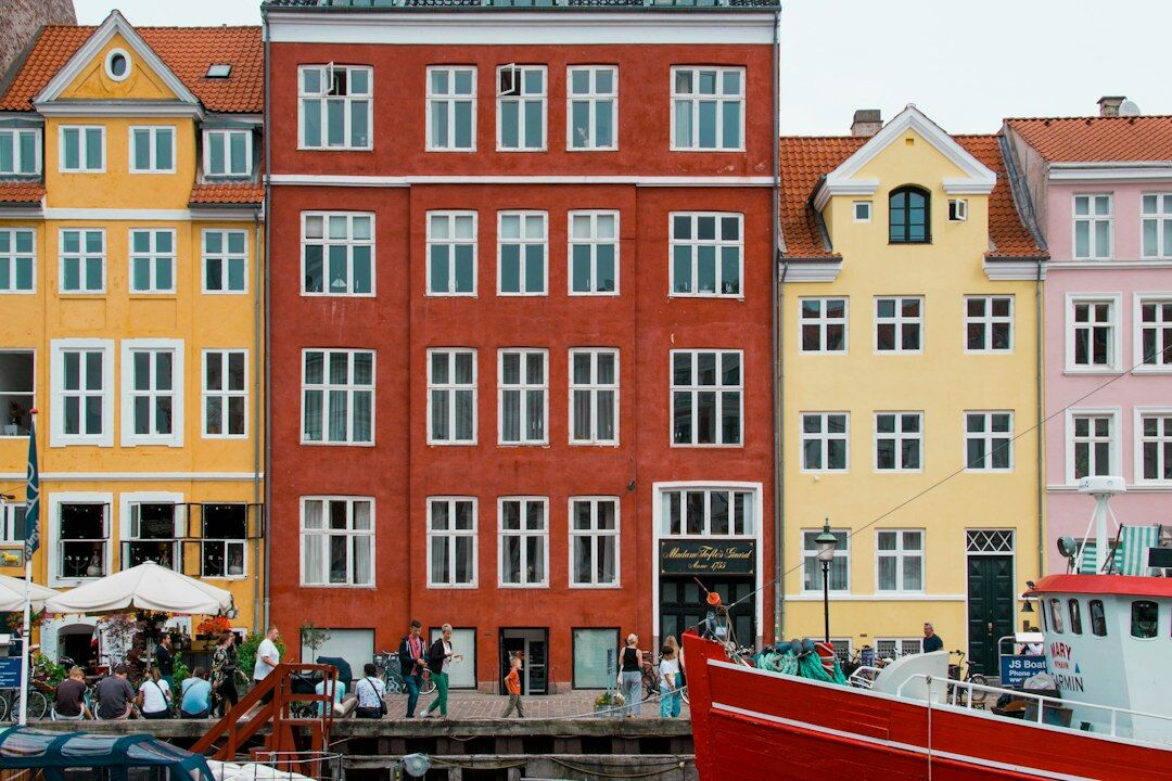 Colorful houses along Nyhavn harbor with bicycles in Copenhagen